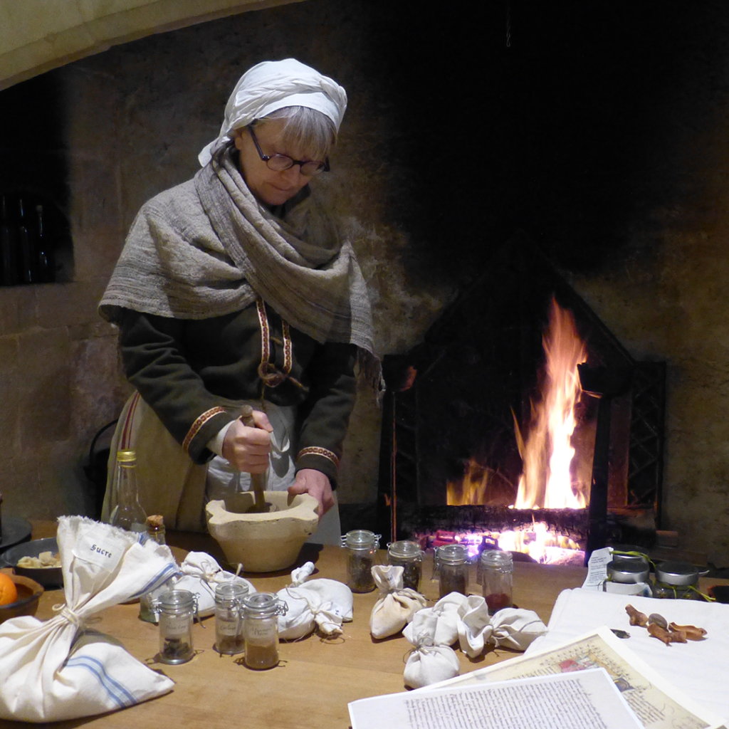 Une femme prépare un repas médiéval